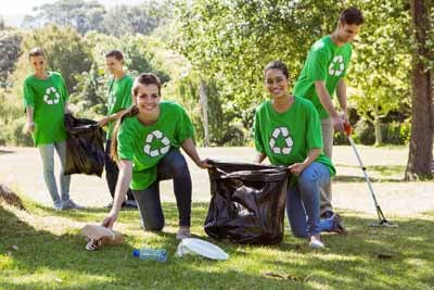 Volunteers in group t-shirts cleaning up their local park